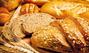 assortment of baked bread on wood table